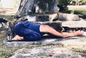 A woman is doing yoga on the ground