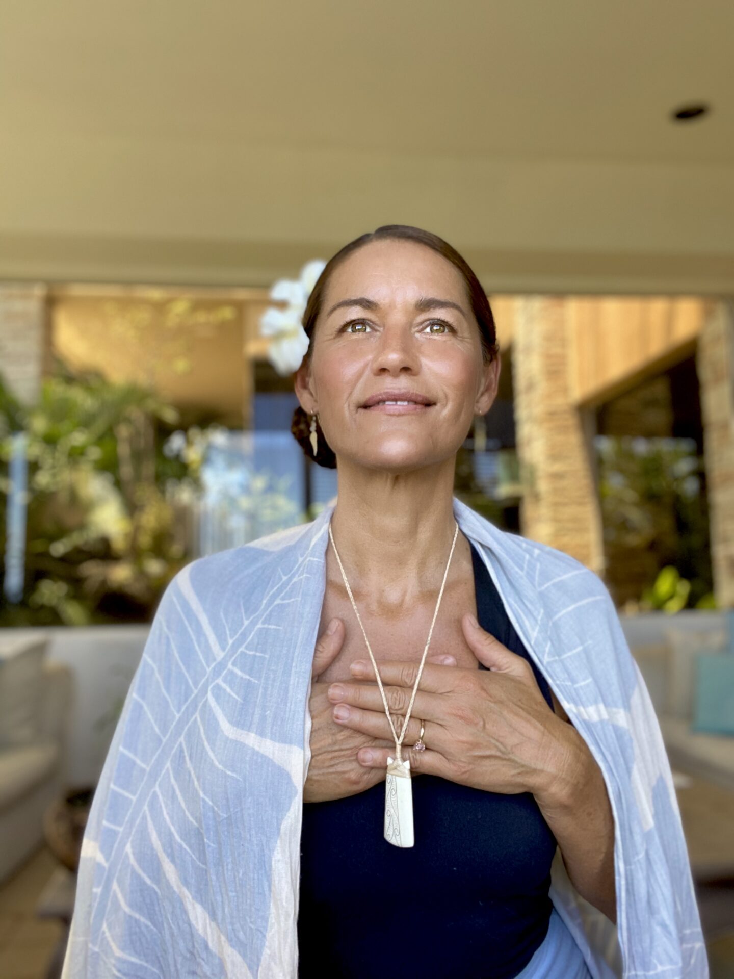 A woman with her hands over her chest.