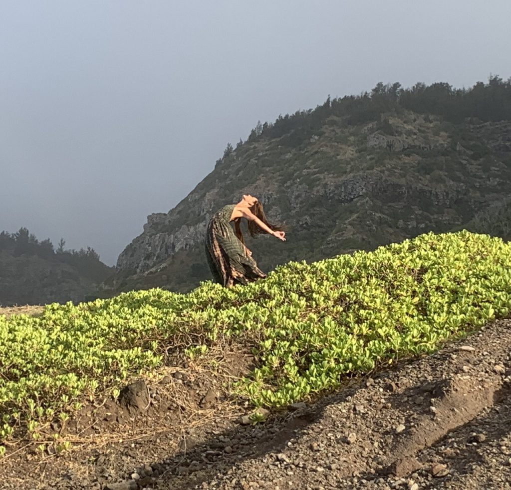 A person riding a skate board on top of a hill