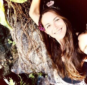 A woman with long hair is smiling for the camera.